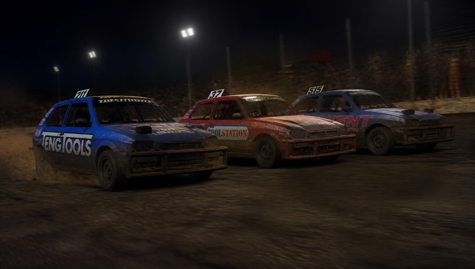 Three 2L saloon stock cars racing three-wide under floodlights on a shale oval